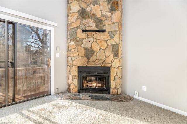 room details with carpet, baseboards, and a stone fireplace