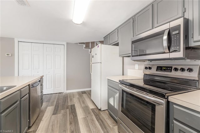 kitchen with light countertops, appliances with stainless steel finishes, and gray cabinetry