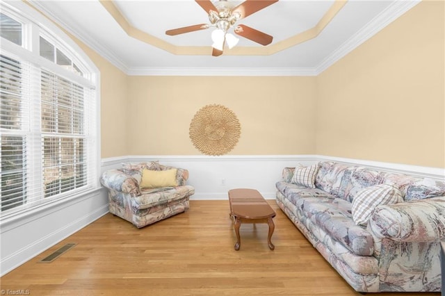 4455 Greystone Place Ct, Winston-Salem, NC 27106 - living room with a tray ceiling, plenty of natural light, light wood-type flooring, ceiling fan, and ornamental molding