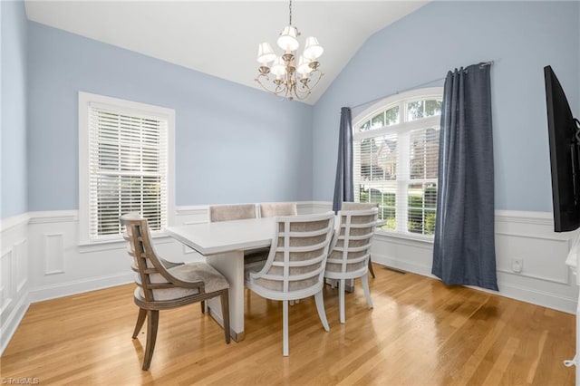 4455 Greystone Place Ct, Winston-Salem, NC 27106 - dining space featuring a chandelier, a wainscoted wall, lofted ceiling, light wood finished floors, and a decorative wall