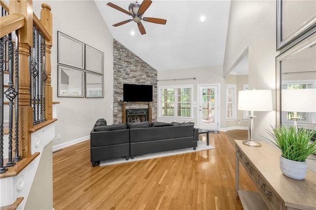 4455 Greystone Place Ct, Winston-Salem, NC 27106 - living area with light wood finished floors, ceiling fan, high vaulted ceiling, and a stone fireplace