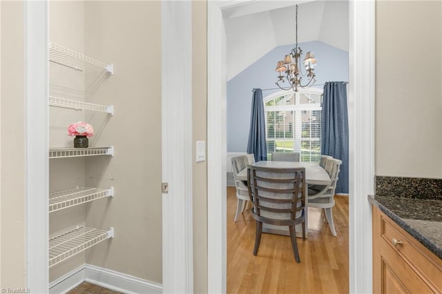 4455 Greystone Place Ct, Winston-Salem, NC 27106 - dining space with a chandelier, light wood-style floors, and vaulted ceiling