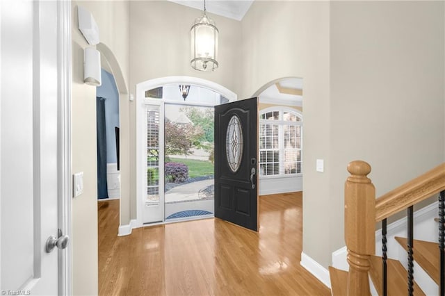 4455 Greystone Place Ct, Winston-Salem, NC 27106 - foyer with wood finished floors, arched walkways, a towering ceiling, ornamental molding, and stairs