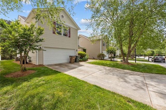 view of side of home with an attached garage, driveway, and a lawn