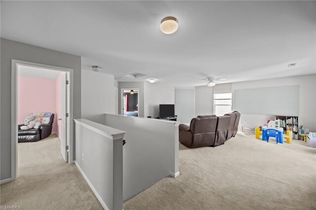 carpeted living room with ceiling fan