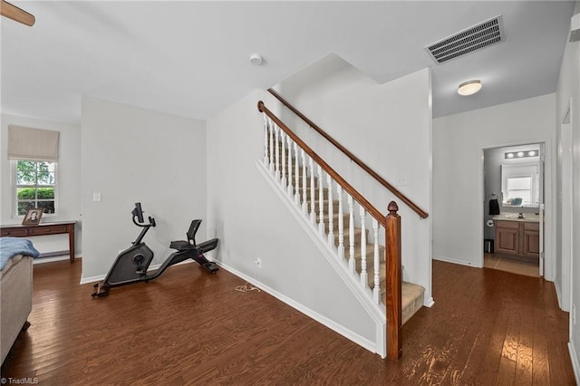 stairs featuring wood finished floors and baseboards