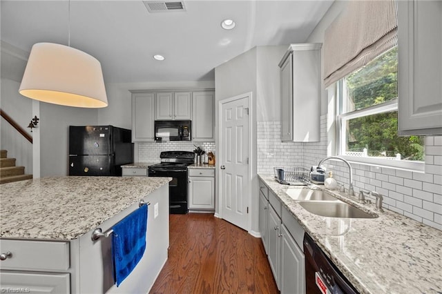 kitchen with black appliances, a sink, dark wood-style flooring, decorative backsplash, and recessed lighting