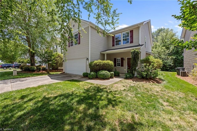 traditional-style home with a garage, concrete driveway, and a front yard