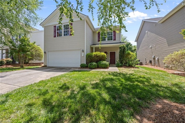 traditional-style house featuring a garage, driveway, and a front lawn