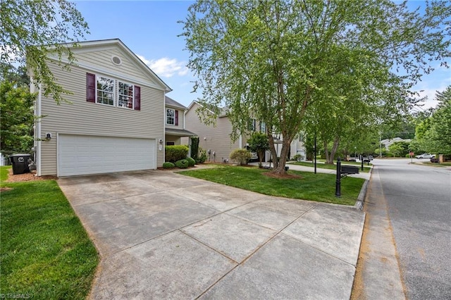 view of front of house featuring an attached garage, driveway, and a front yard