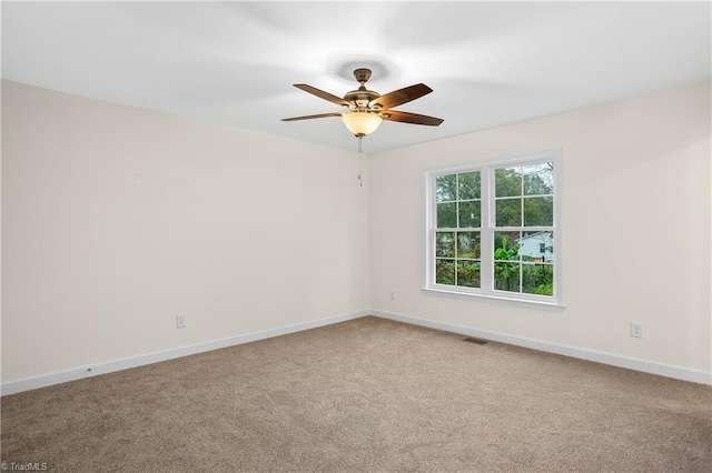 spare room with visible vents, baseboards, ceiling fan, and carpet floors