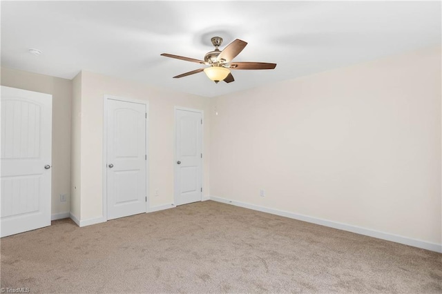 unfurnished bedroom featuring carpet flooring, a ceiling fan, and baseboards