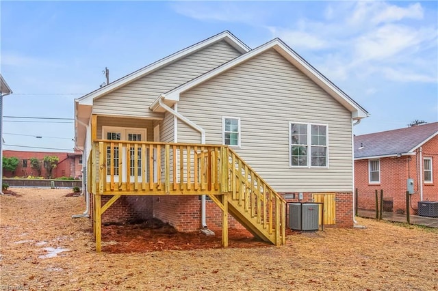 back of house with cooling unit, stairs, and fence