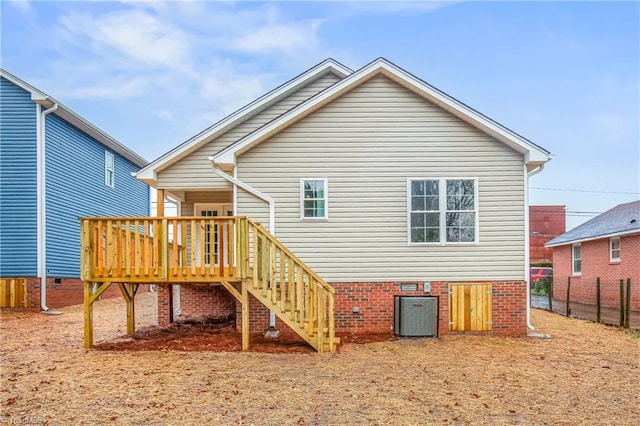 rear view of property featuring fence, a wooden deck, central AC, stairs, and crawl space