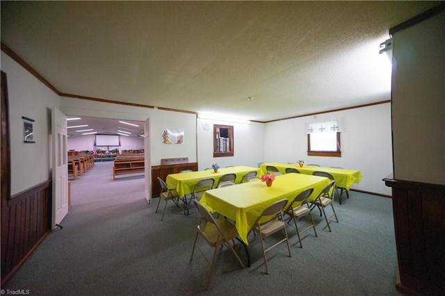 carpeted dining space featuring a textured ceiling, crown molding, and wooden walls