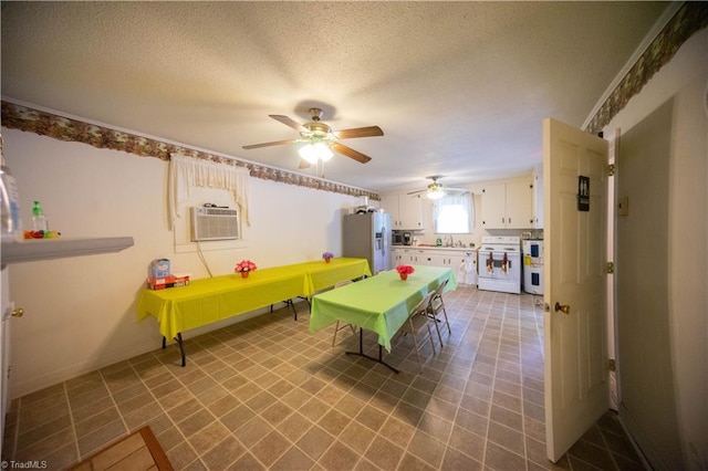 recreation room featuring ceiling fan, cooling unit, sink, and a textured ceiling