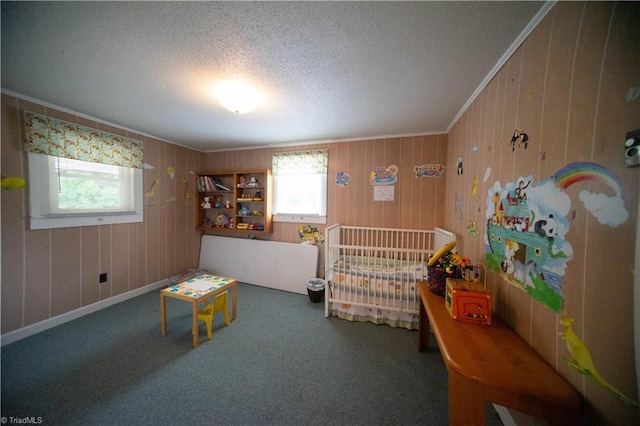 bedroom with carpet, wood walls, and a textured ceiling