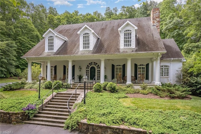 4432 Bent Tree Farm Rd, Winston-Salem, NC 27104 - cape cod home with a porch, stucco siding, and a chimney