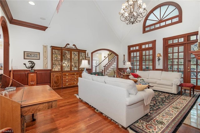 4432 Bent Tree Farm Rd, Winston-Salem, NC 27104 - living room featuring arched walkways, wood finished floors, high vaulted ceiling, crown molding, and a chandelier