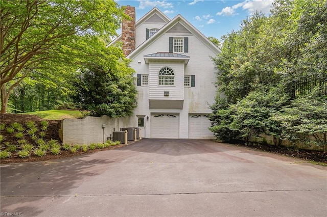 4432 Bent Tree Farm Rd, Winston-Salem, NC 27104 - view of front of home featuring a standing seam roof, a chimney, asphalt driveway, an attached garage, and a metal roof