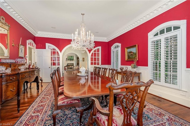 4432 Bent Tree Farm Rd, Winston-Salem, NC 27104 - dining room featuring wood finished floors, a chandelier, ornamental molding, and wainscoting