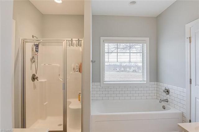 full bathroom with a stall shower and a garden tub