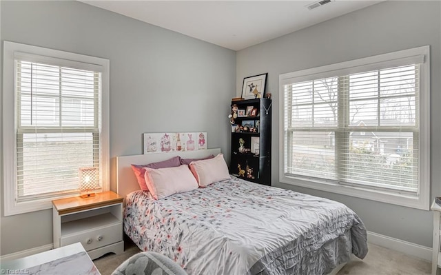 bedroom with carpet, visible vents, and baseboards