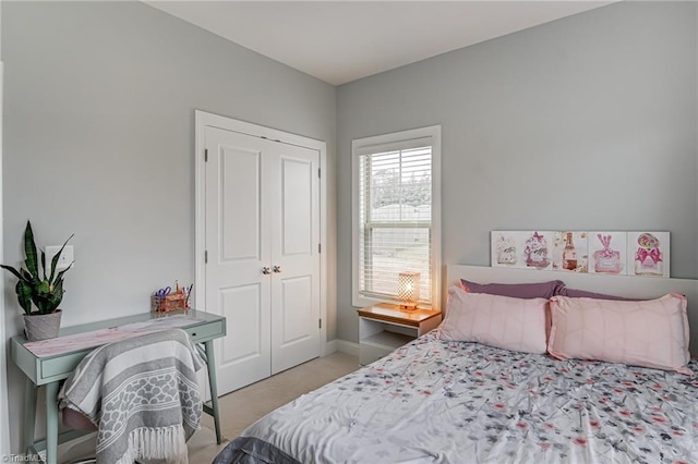 bedroom featuring light carpet and baseboards