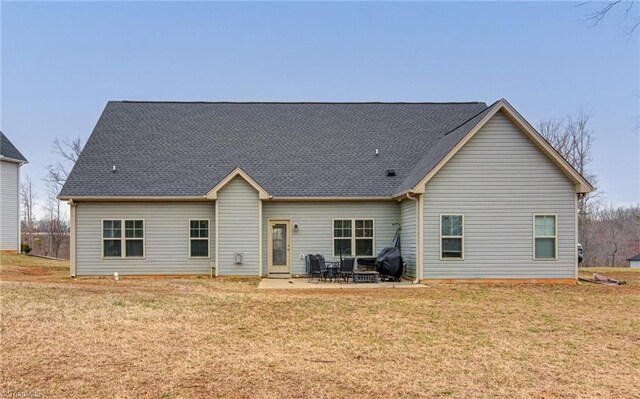 back of property featuring a yard and a patio