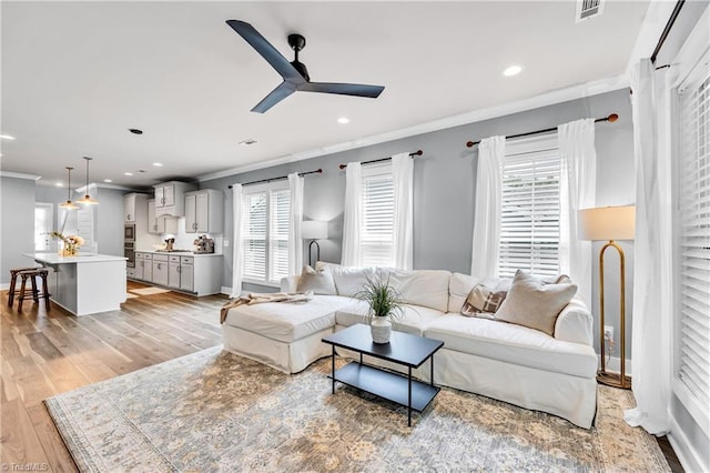5166 Whaitley Ln, Greensboro, NC 27407 - living area featuring ornamental molding, ceiling fan, light wood-type flooring, healthy amount of natural light, and recessed lighting