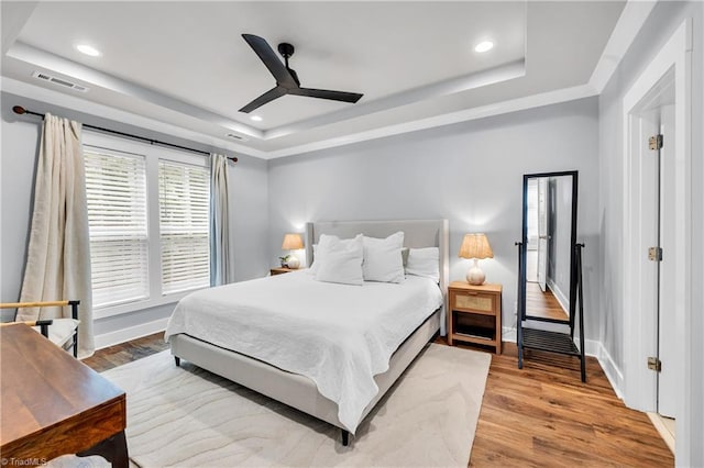 5166 Whaitley Ln, Greensboro, NC 27407 - bedroom with a tray ceiling, recessed lighting, wood finished floors, baseboards, and a ceiling fan
