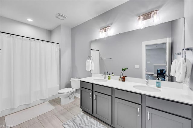 5166 Whaitley Ln, Greensboro, NC 27407 - bathroom featuring double vanity, toilet, and shower / bathtub combination with curtain