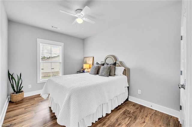 5166 Whaitley Ln, Greensboro, NC 27407 - bedroom with baseboards, dark wood-style floors, and a ceiling fan
