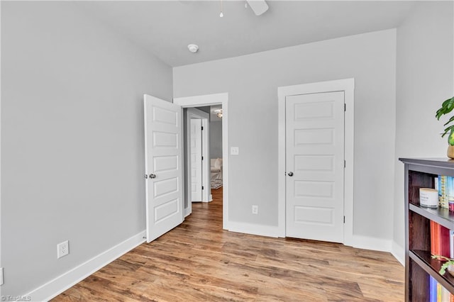 5166 Whaitley Ln, Greensboro, NC 27407 - unfurnished bedroom featuring wood finished floors, baseboards, and a ceiling fan