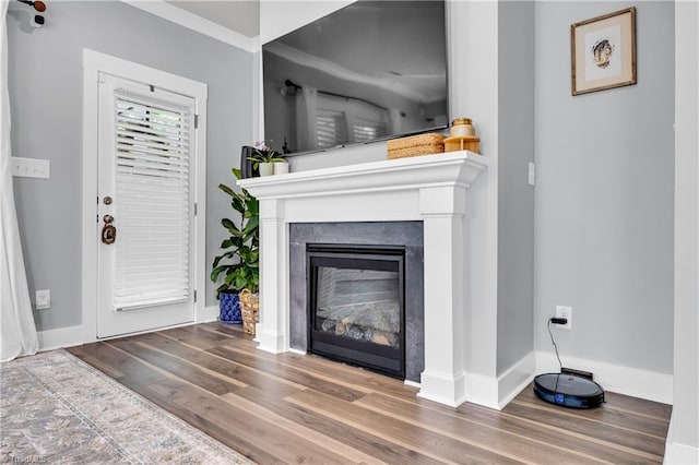 5166 Whaitley Ln, Greensboro, NC 27407 - unfurnished living room with wood finished floors, a glass covered fireplace, and baseboards
