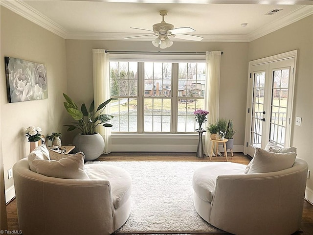 living room featuring ornamental molding, french doors, baseboards, and wood finished floors