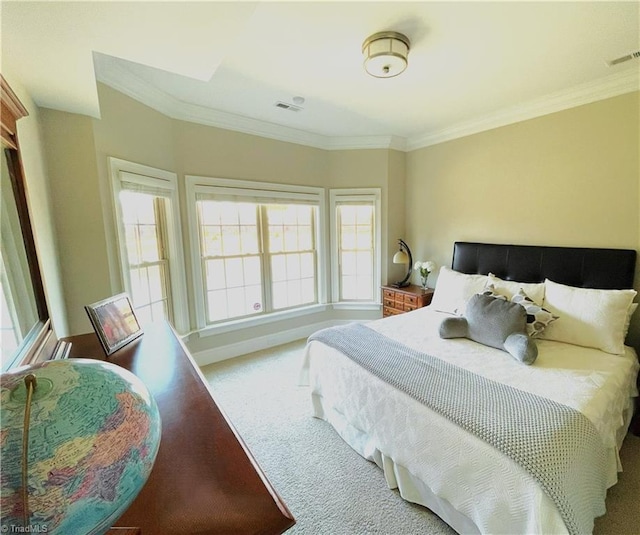 carpeted bedroom with visible vents, crown molding, and baseboards