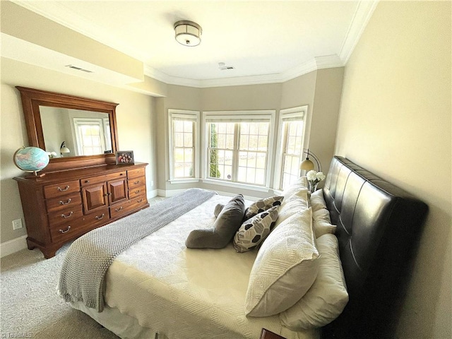 bedroom featuring light carpet, baseboards, visible vents, and ornamental molding