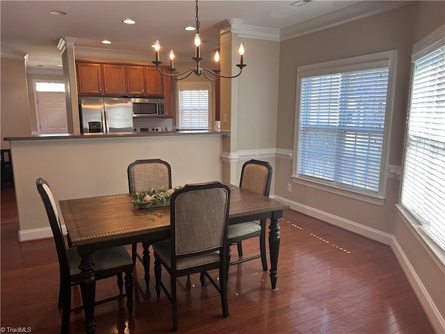 dining space with crown molding, baseboards, dark wood finished floors, recessed lighting, and a notable chandelier