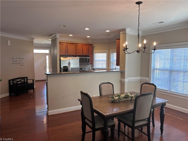 dining area with visible vents, crown molding, baseboards, an inviting chandelier, and dark wood-style flooring