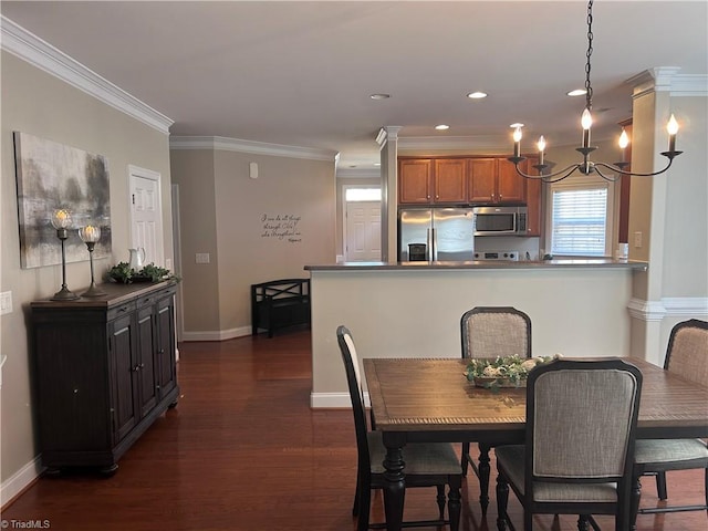 dining area with dark wood-style floors, crown molding, and baseboards