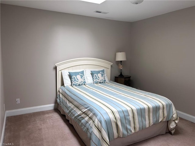 carpeted bedroom featuring baseboards and visible vents