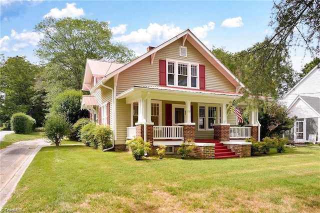 view of front of home with a porch and a front lawn