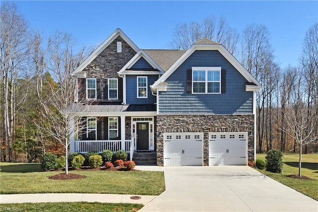 view of front of property with stone siding, covered porch, concrete driveway, and a front yard