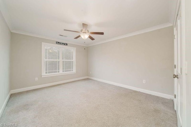 unfurnished room with crown molding, light colored carpet, and ceiling fan