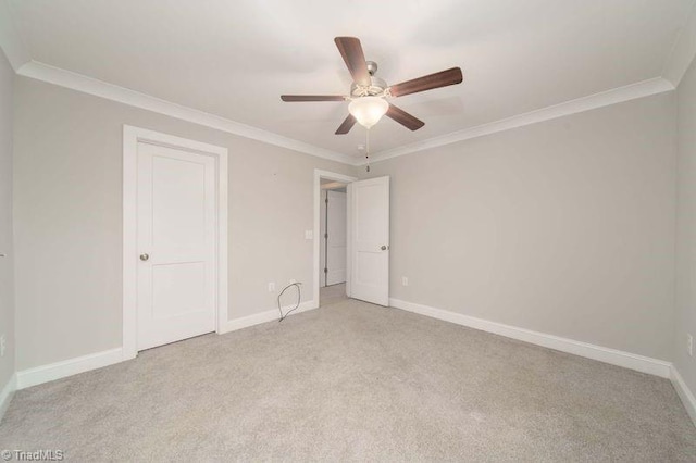 unfurnished bedroom featuring ceiling fan, ornamental molding, and light colored carpet