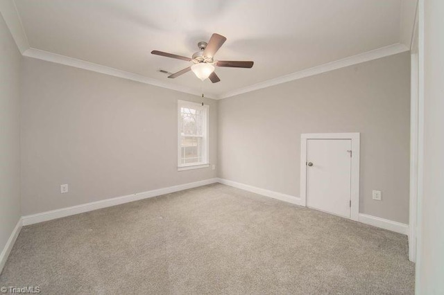 empty room with ornamental molding, light carpet, and ceiling fan