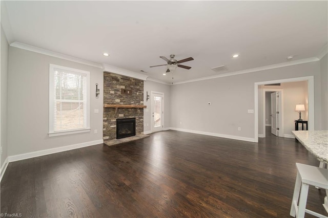 unfurnished living room with ceiling fan, ornamental molding, dark hardwood / wood-style floors, and a stone fireplace