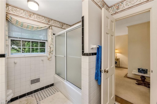 bathroom with visible vents and combined bath / shower with glass door