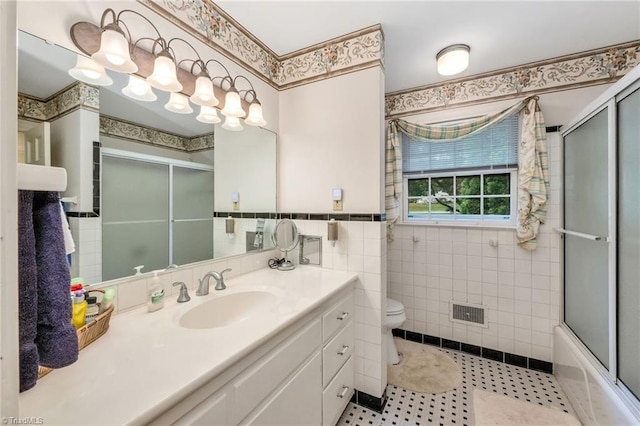 full bathroom with visible vents, tile walls, vanity, tile patterned floors, and toilet